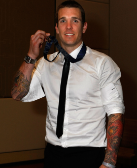 Dane Swan proudly displays his Brownlow Medal, won in 2011.