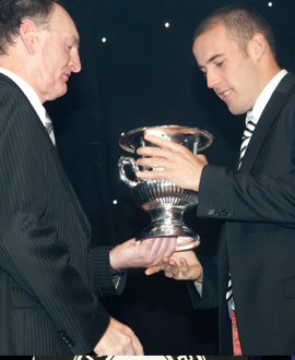 Ryan Cook accepts the VFL best and fairest award from Max Richardson.