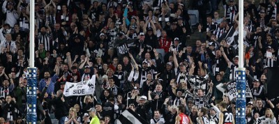 Collingwood supporters celebrate a goal in the round 20 contest against Sydney in 2013.