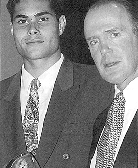 Mal Michael accepts the Harry Collier Trophy from Barry Price in 1997.