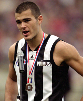 Chris Tarrant accepts the ANZAC Day Medal after kicking five goals in the 2001 loss.